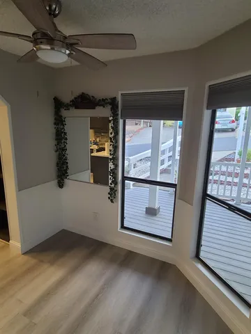 a bathroom with a granite countertop sink a mirror a vanity and bathtub