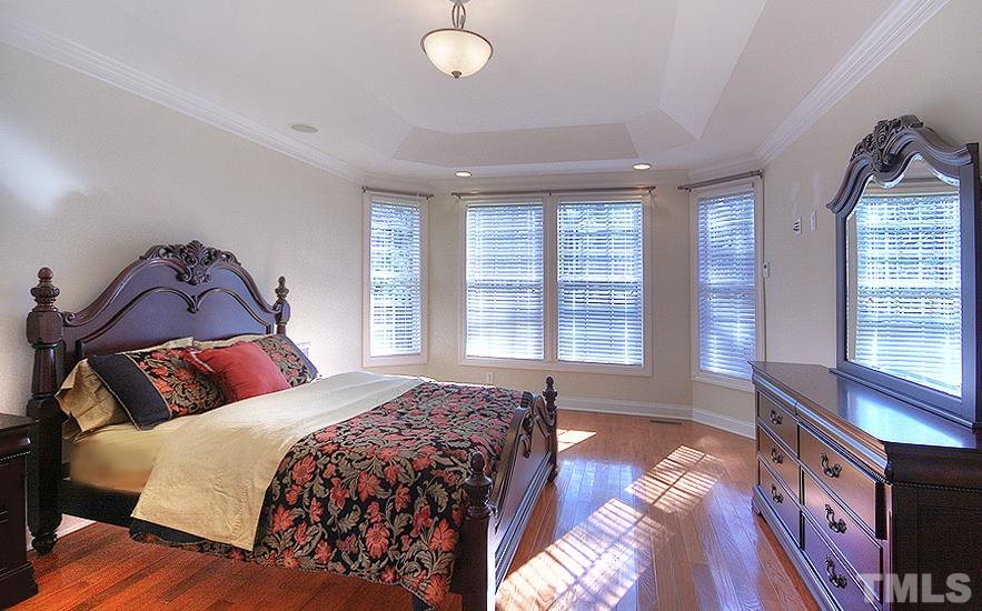 10008 Darling Street Raleigh, NC 27613 - Photo 12 of 24 a bedroom with a bed and a large window