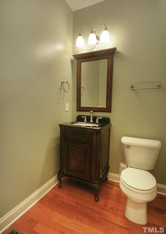 10008 Darling Street Raleigh, NC 27613 - Photo 14 of 24 a bathroom with a toilet a sink and mirror