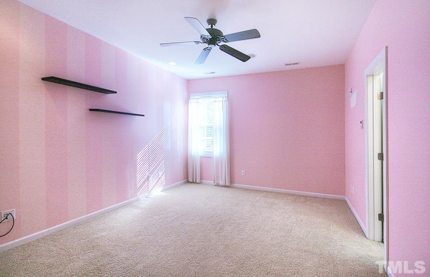 10008 Darling Street Raleigh, NC 27613 - Photo 17 of 24 a view of a livingroom with a ceiling fan and window