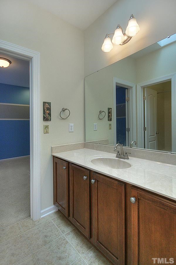 10008 Darling Street Raleigh, NC 27613 - Photo 21 of 24 a bathroom with a double vanity sink and a mirror
