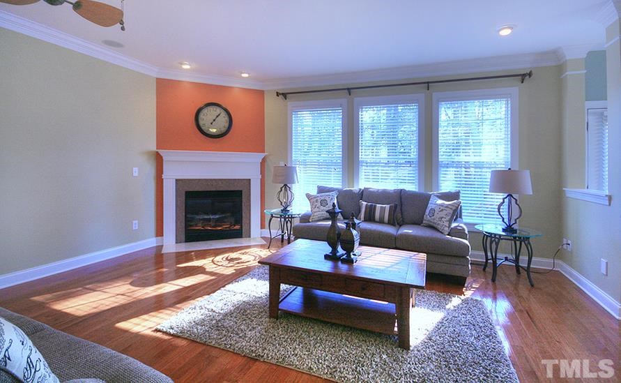 10008 Darling Street Raleigh, NC 27613 - Photo 9 of 24 a living room with furniture and a fireplace