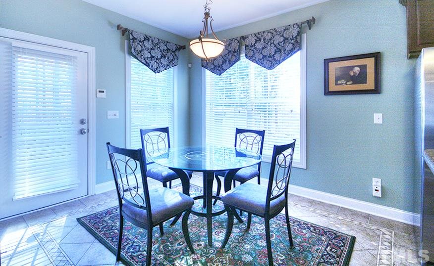 10008 Darling Street Raleigh, NC 27613 - Photo 10 of 24 a view of a dining room with furniture window and wooden floor