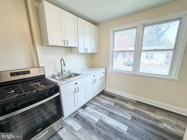 a kitchen with a stove and white cabinets
