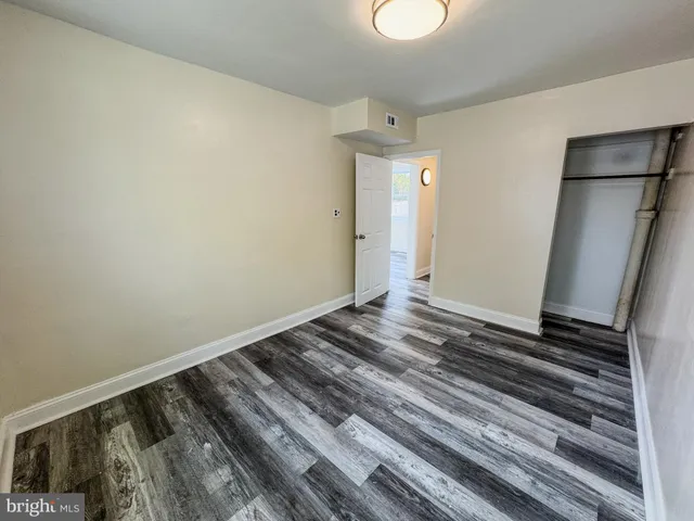 a view of a room with wooden floor