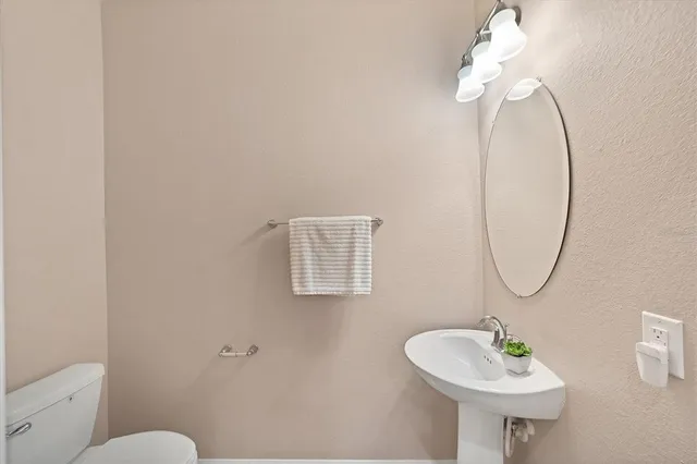 a bathroom with a sink a mirror and a toilet