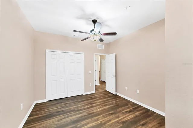 a view of a room with a sink and a chandelier fan