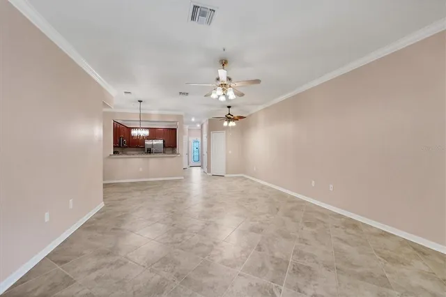 a view of a livingroom with a chandelier fan and fire place