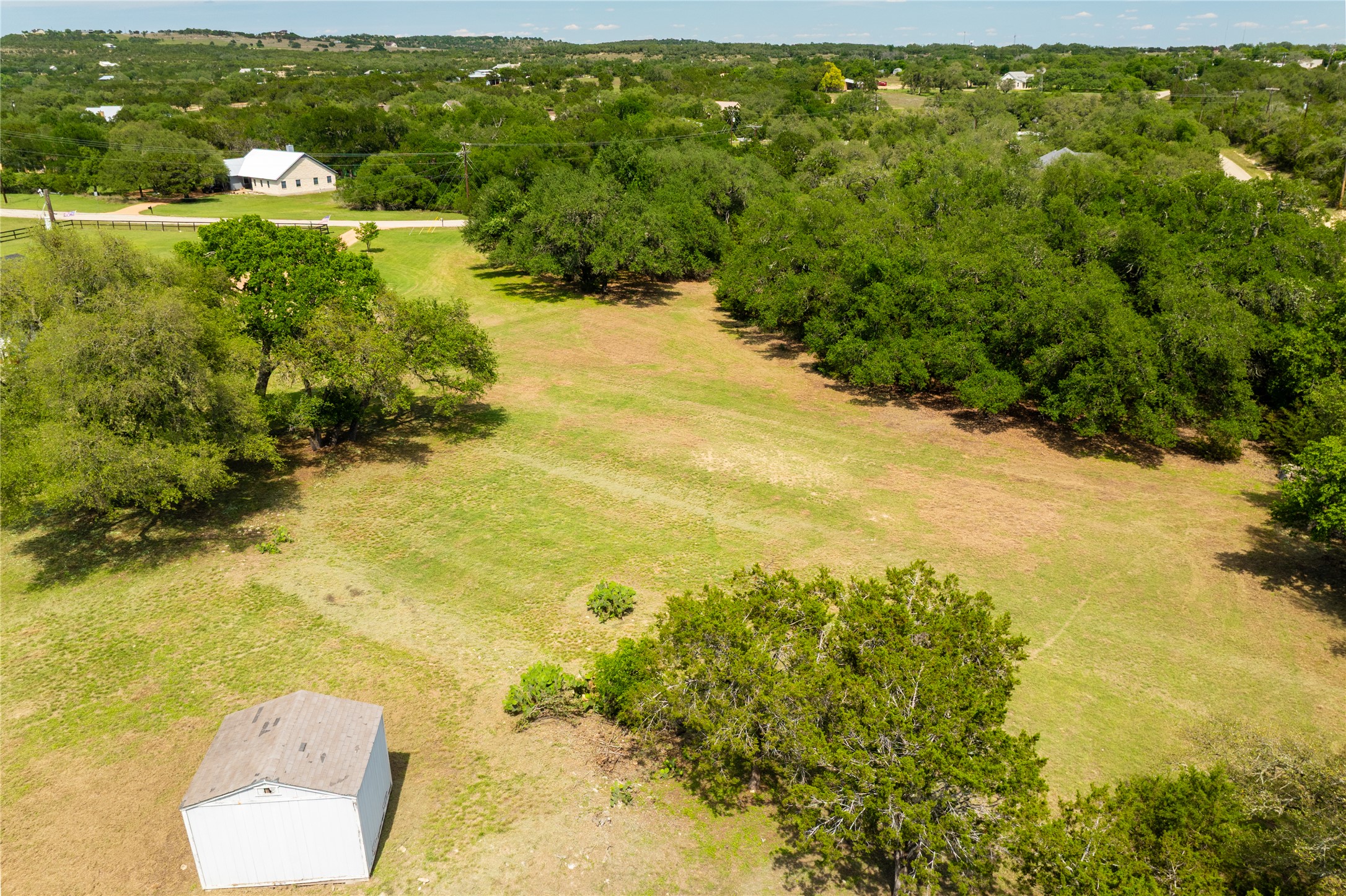 187 Beauchamp Road Dripping Springs, TX 78620 - Photo 18 of 19 Expansive open land featuring a mix of mature trees and grassy areas