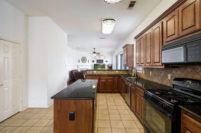 a kitchen with stainless steel appliances granite countertop a stove and a sink