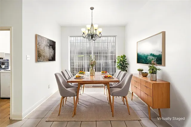 a dining room with furniture a chandelier and window