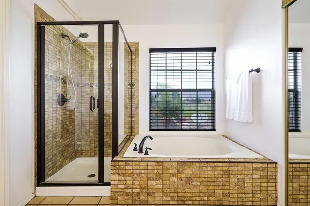 a bathroom with a bathtub and shower