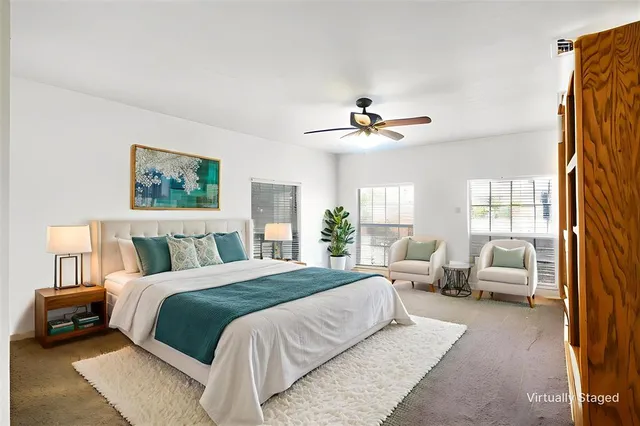 a bedroom with a large bed couch and a window