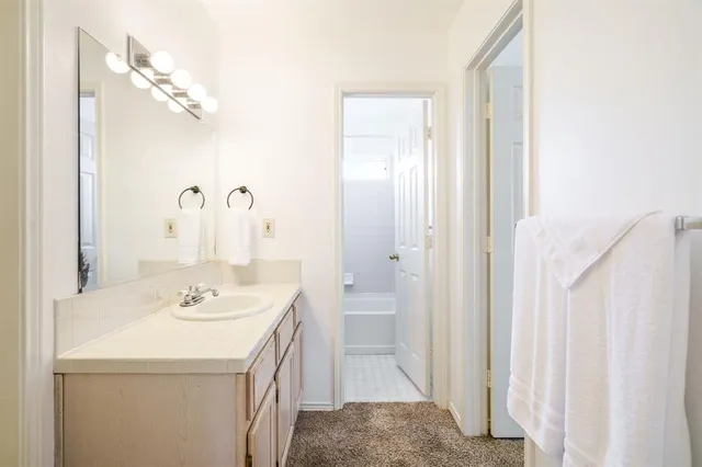 a bathroom with a sink a vanity and a mirror