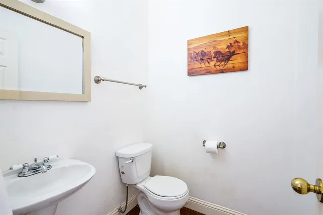 a white toilet sitting next to a bathroom sink