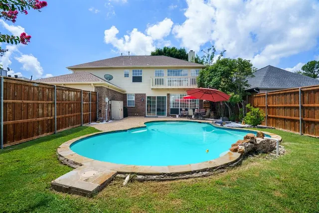 a view of a house with backyard sitting area and tub