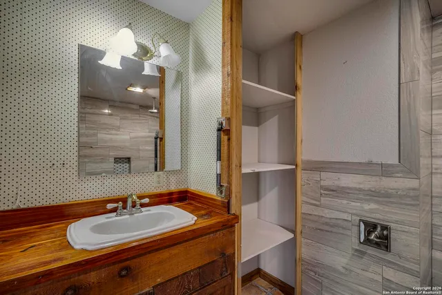 a bathroom with a sink and a mirror