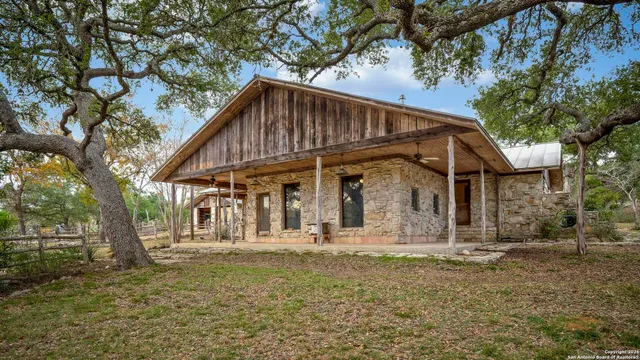 a view of a house with large trees