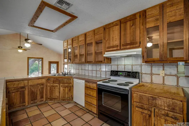 a kitchen with a stove and a sink