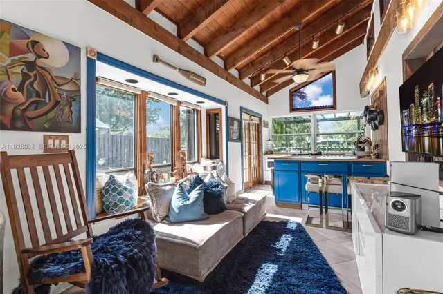 a living room with furniture and a floor to ceiling window