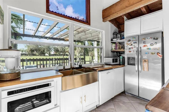 a kitchen with stainless steel appliances a sink and cabinets