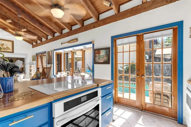 a dining hall with stainless steel appliances granite countertop a sink and cabinets