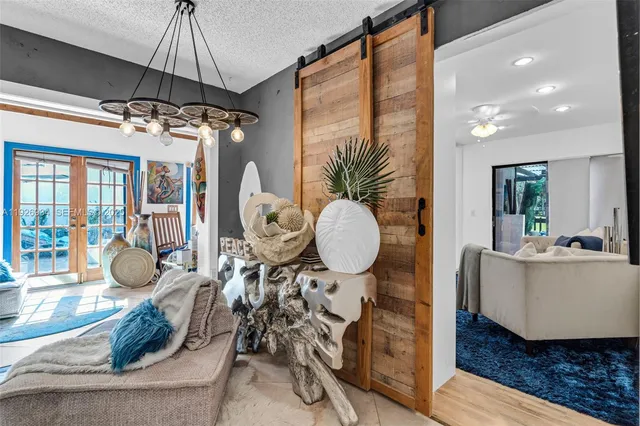 a bedroom with a bed couch and a large window