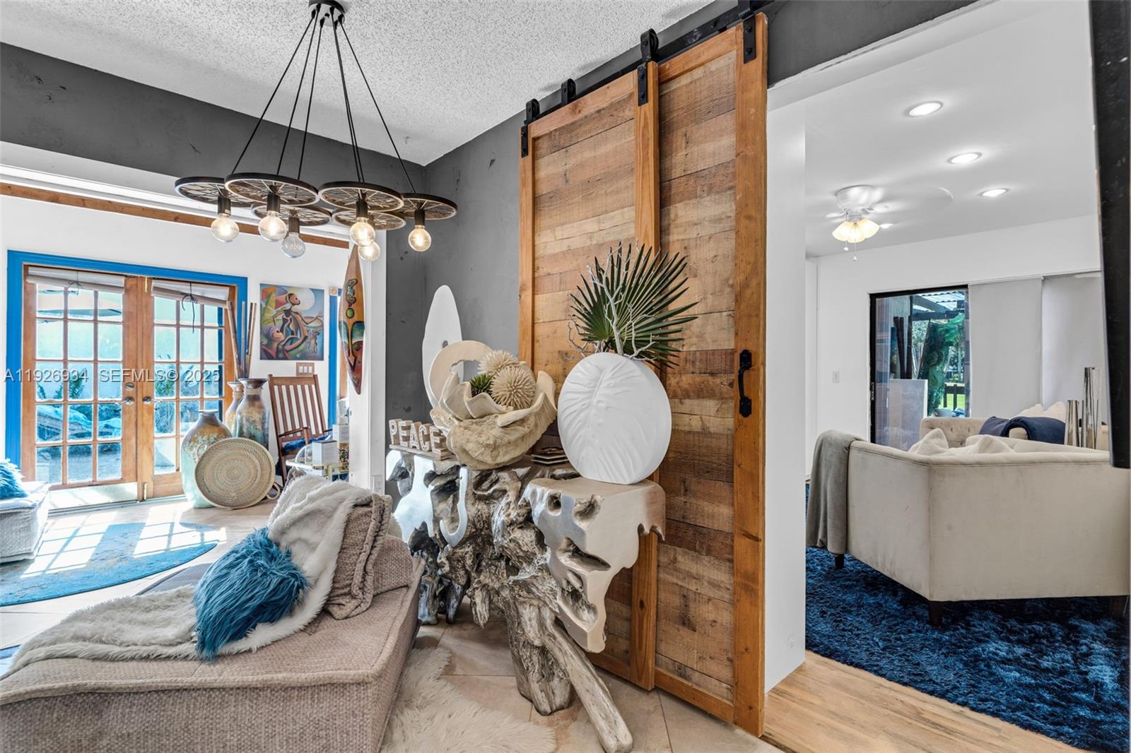 1420 West Sandpiper Circle, Unit 1420 Pembroke Pines, FL 33026 - Photo 16 of 38 a room with wooden floor and a chandelier