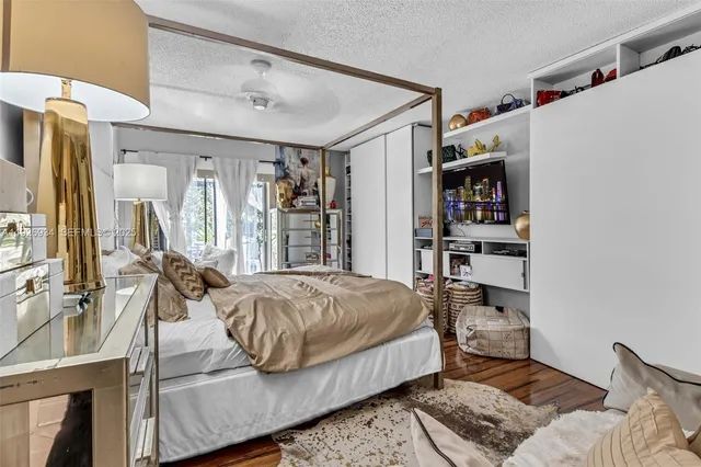 a bedroom with a bed a mirror and a window