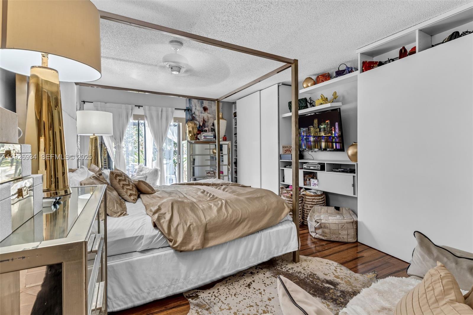 1420 West Sandpiper Circle, Unit 1420 Pembroke Pines, FL 33026 - Photo 17 of 38 a bedroom with a bed couch and a large window