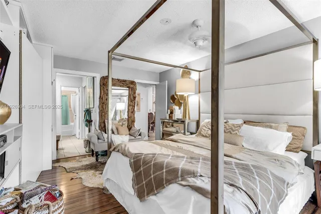 a bedroom with a bed and wooden floor