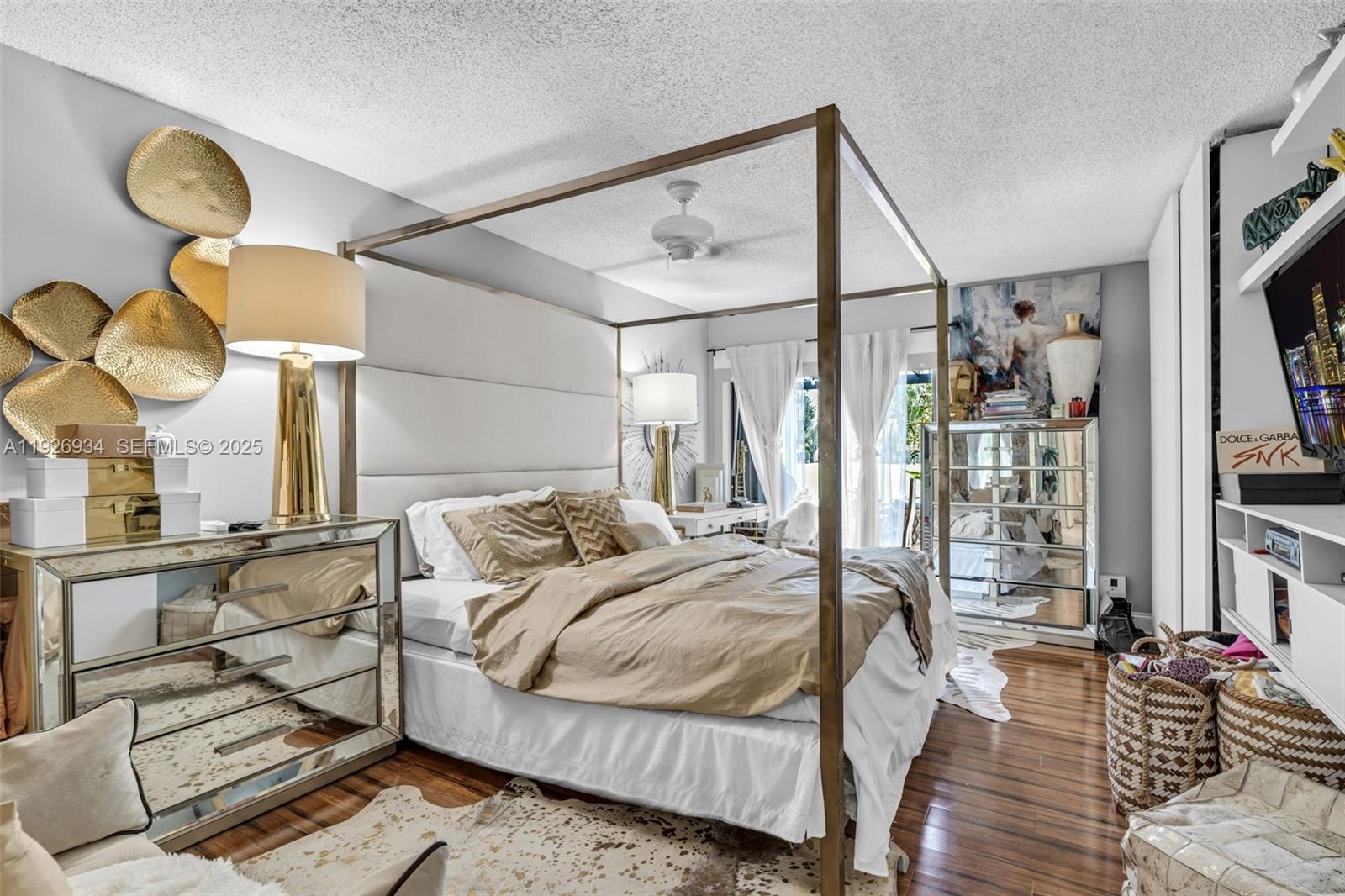 1420 West Sandpiper Circle, Unit 1420 Pembroke Pines, FL 33026 - Photo 19 of 38 a bedroom with a bed and wooden floor