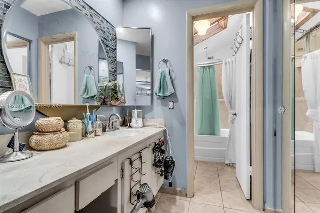 a bathroom with a shower and a sink