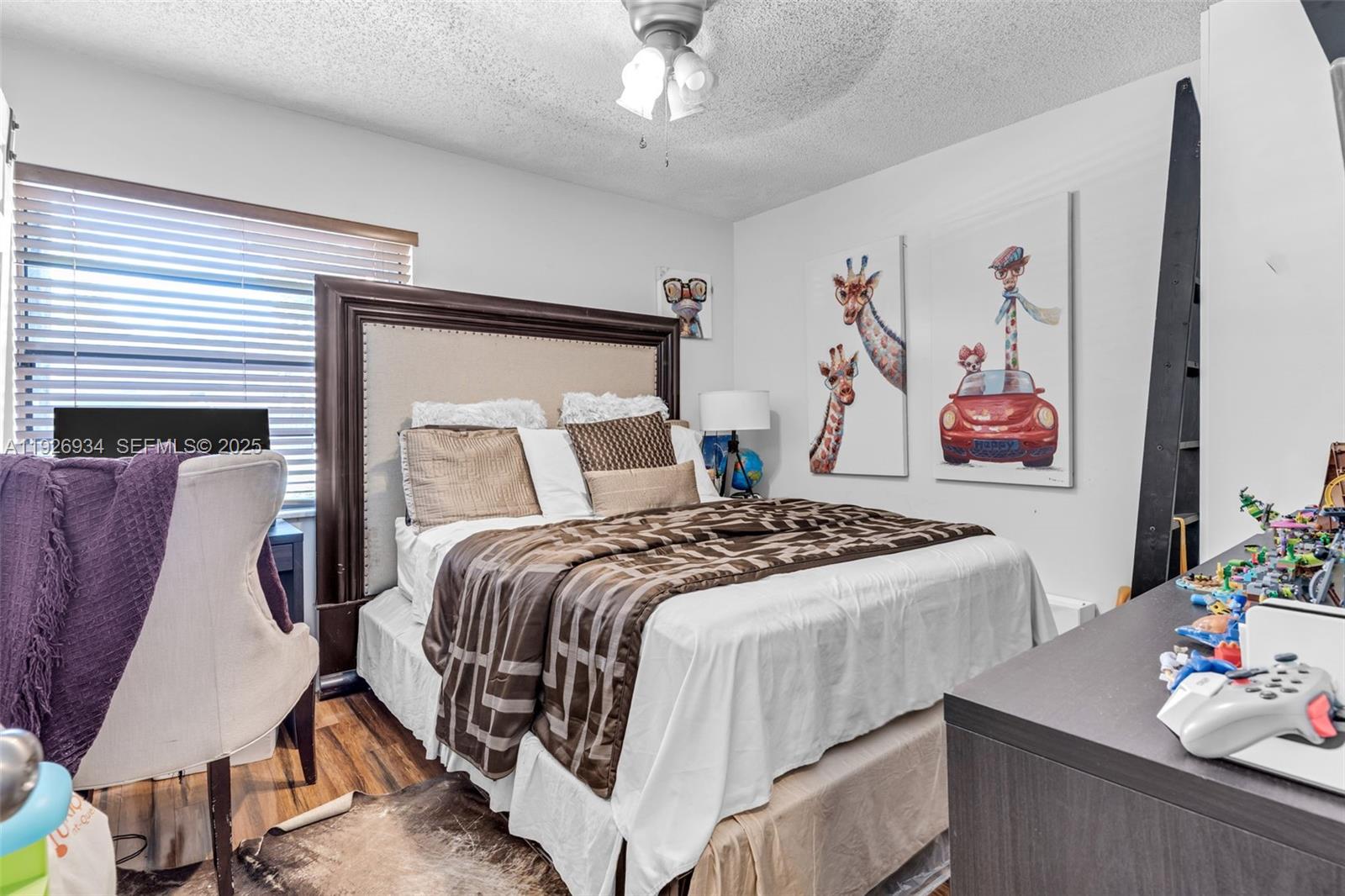 1420 West Sandpiper Circle, Unit 1420 Pembroke Pines, FL 33026 - Photo 24 of 38 a bedroom with a bed and a chandelier