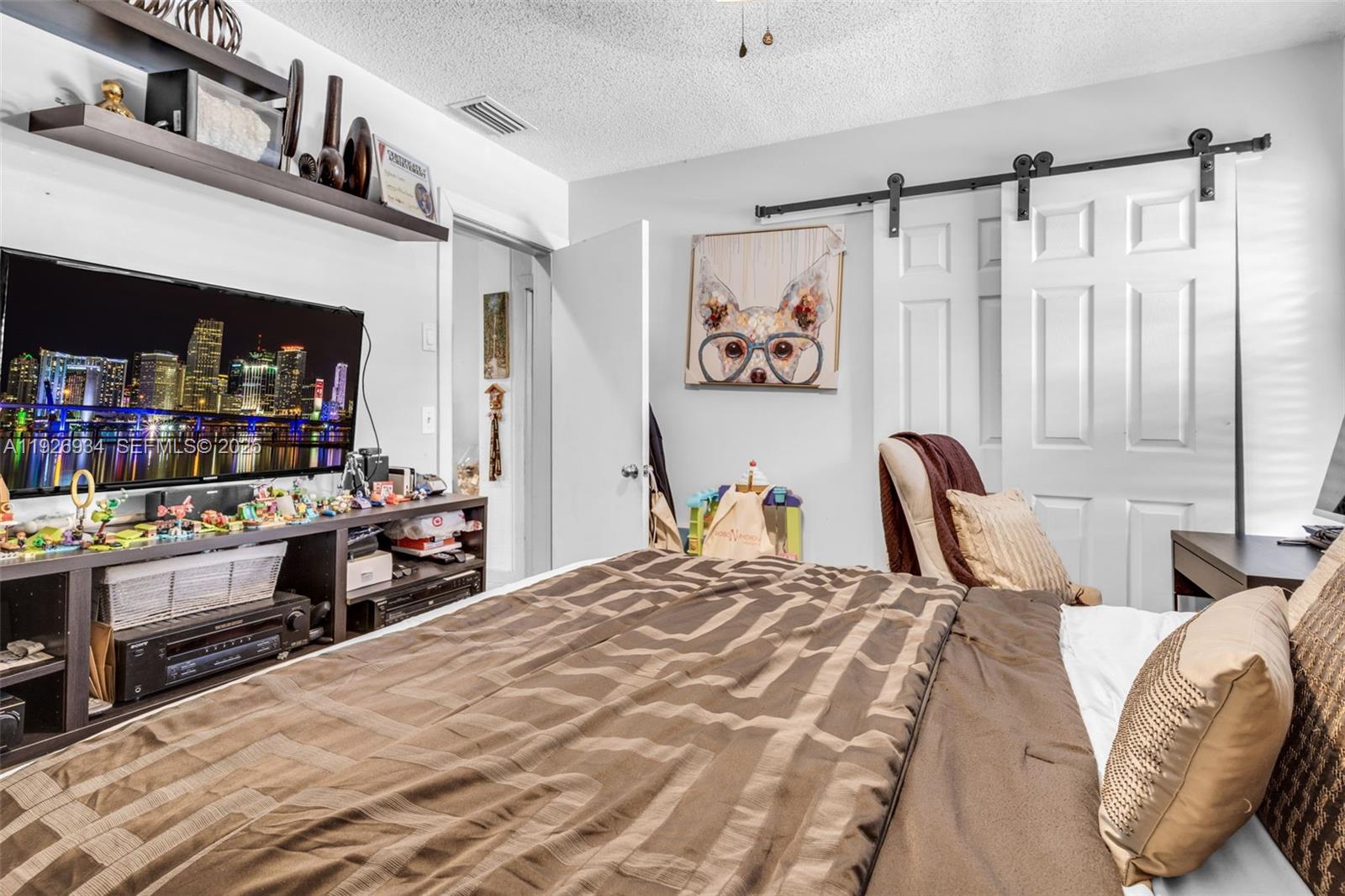 1420 West Sandpiper Circle, Unit 1420 Pembroke Pines, FL 33026 - Photo 25 of 38 a bedroom with a bed and a walk in closet