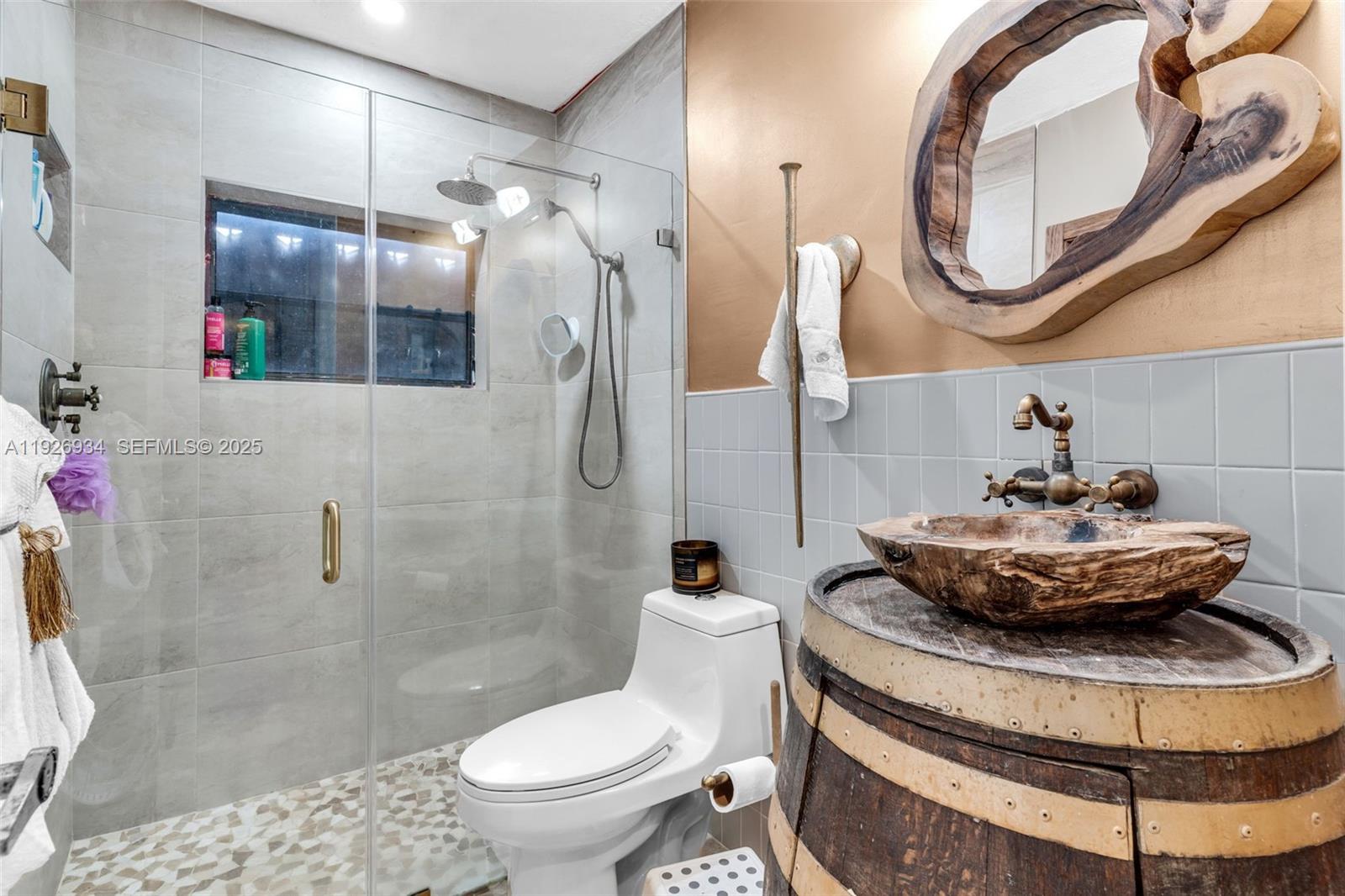 1420 West Sandpiper Circle, Unit 1420 Pembroke Pines, FL 33026 - Photo 26 of 38 a bathroom with a toilet and a mirror