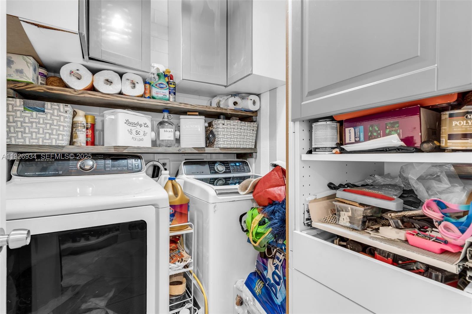 1420 West Sandpiper Circle, Unit 1420 Pembroke Pines, FL 33026 - Photo 29 of 38 a utility room with lots of clutter and cabinets