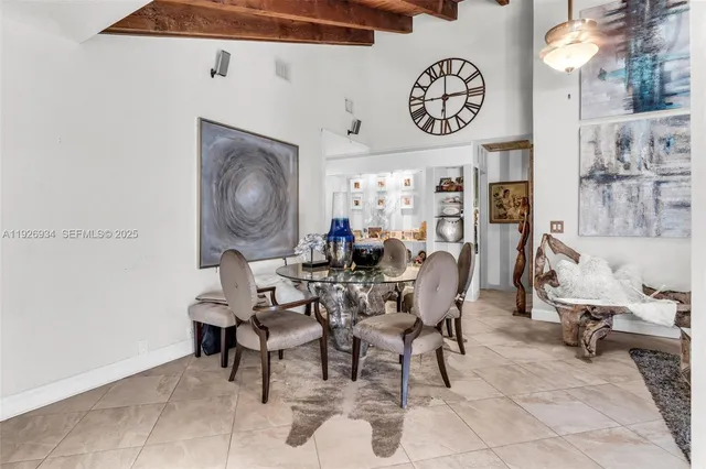 a view of a dining room with furniture and a chandelier