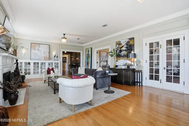 a living room with furniture a flat screen tv and a fireplace
