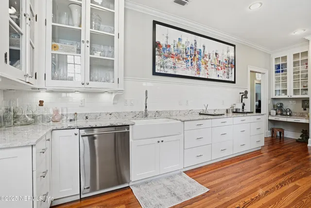 a dining room with furniture and potted plants