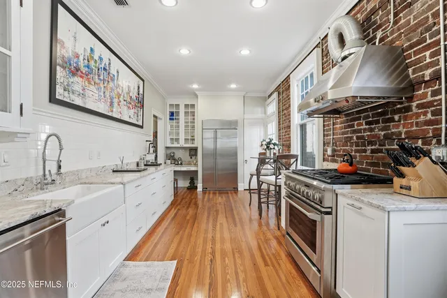 a kitchen with stainless steel appliances granite countertop a sink stove and cabinets