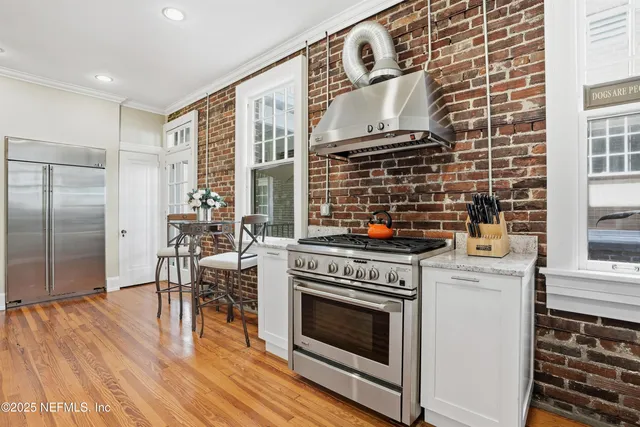 a kitchen with stainless steel appliances granite countertop a stove and a sink