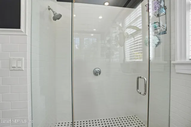 a bathroom with a sink a toilet and a window