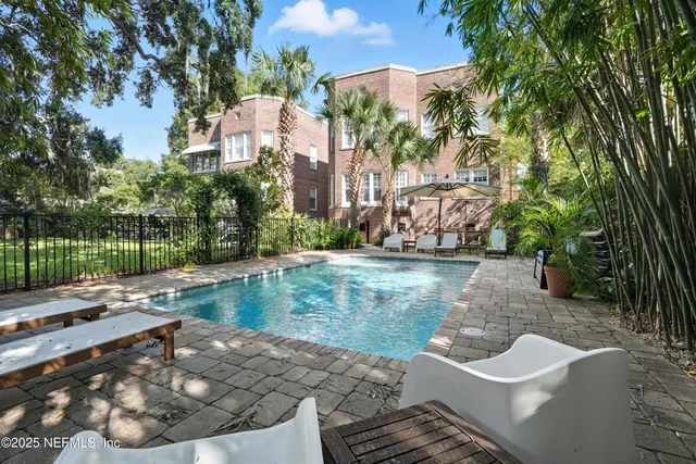 a view of a chairs and table in the balcony