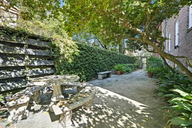 a view of a chairs and table in patio of the house
