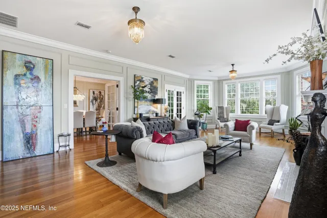 a living room with furniture a large window and a fireplace