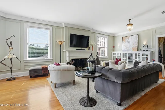 a living room with furniture a fireplace and a flat screen tv