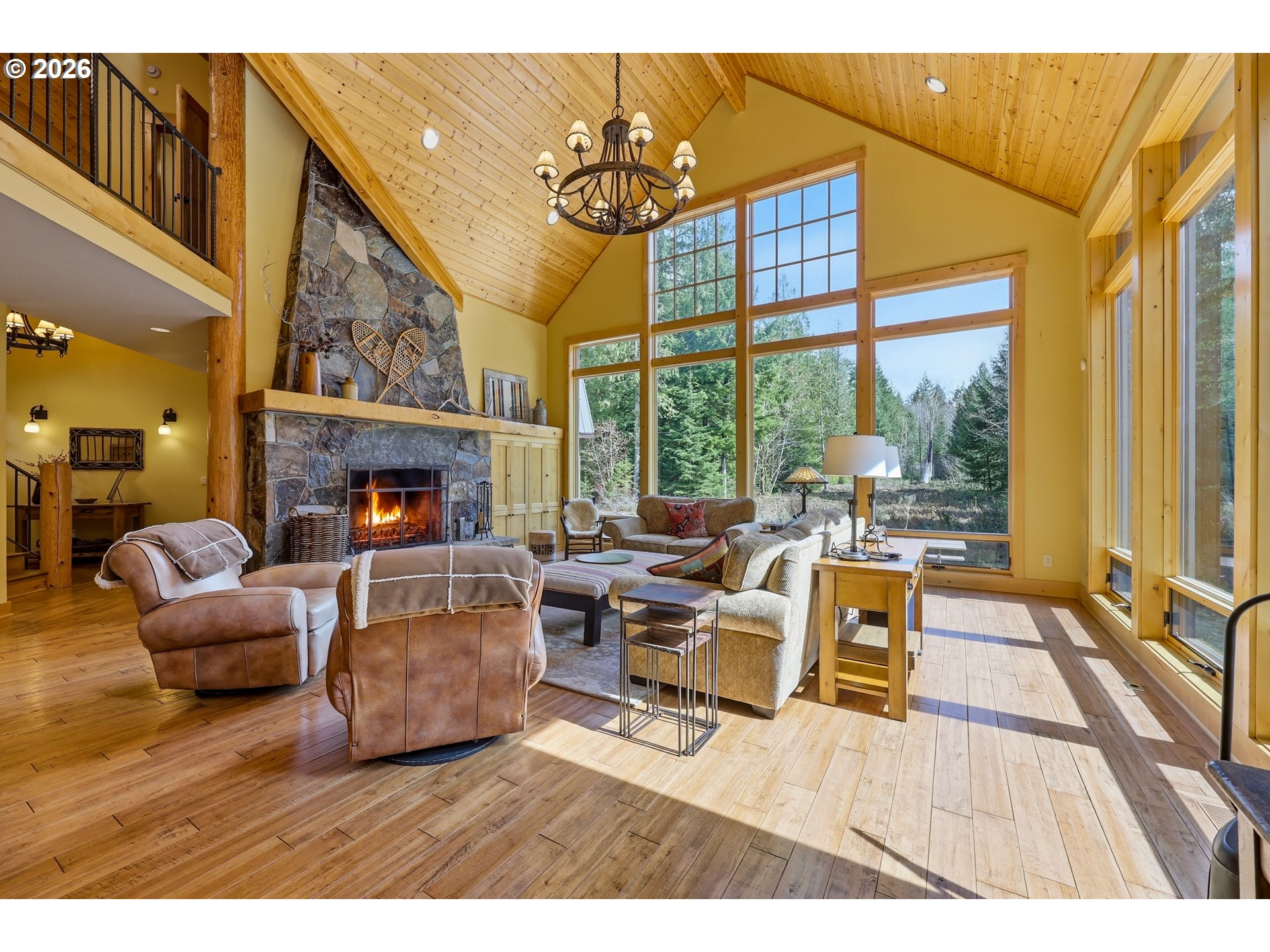 20680 East Glacier View Road Rhododendron, OR 97049 - Photo 17 of 48 a living room with furniture a fireplace and a floor to ceiling window