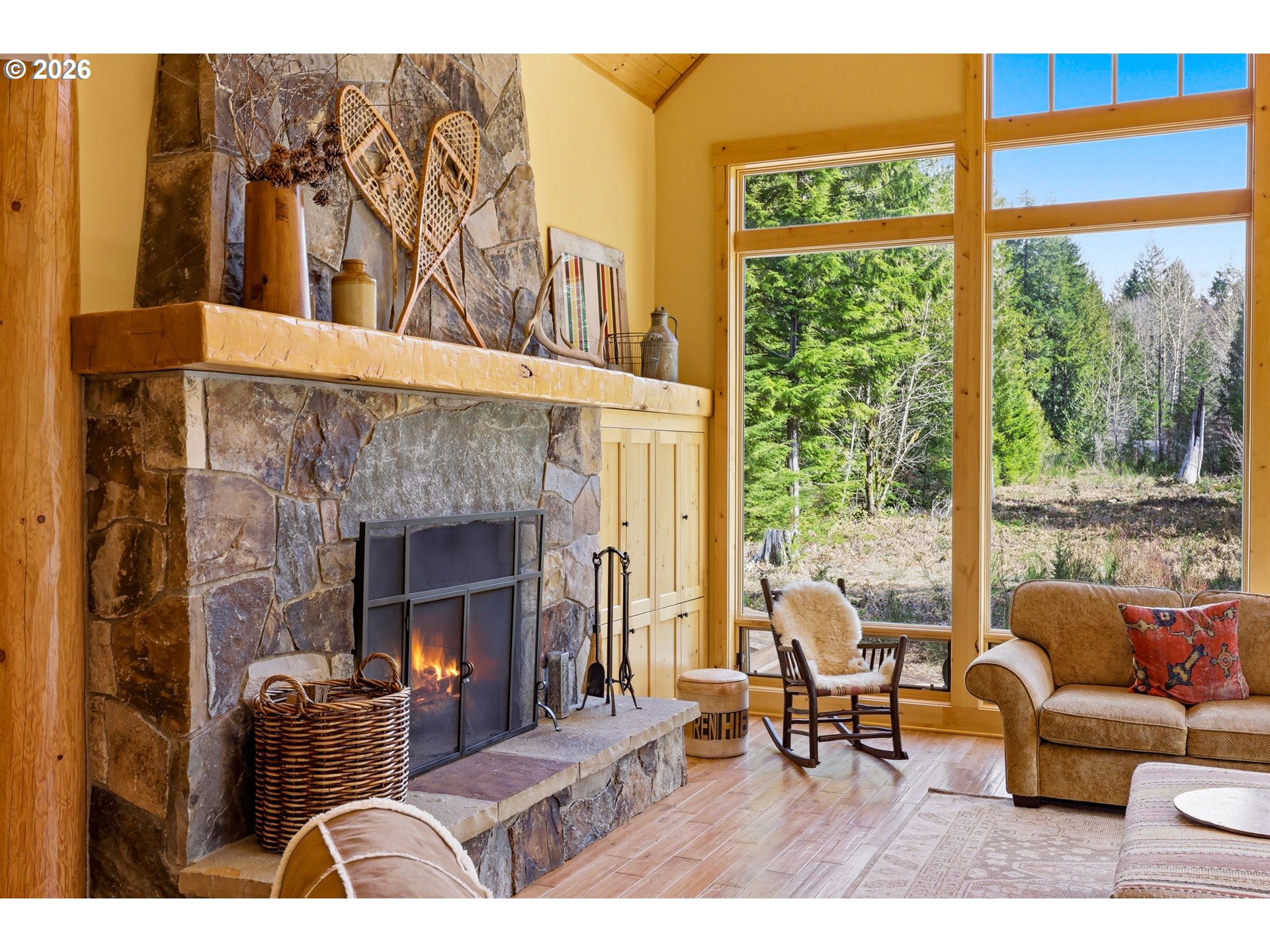 20680 East Glacier View Road Rhododendron, OR 97049 - Photo 21 of 48 a living room with furniture a fireplace and a floor to ceiling window