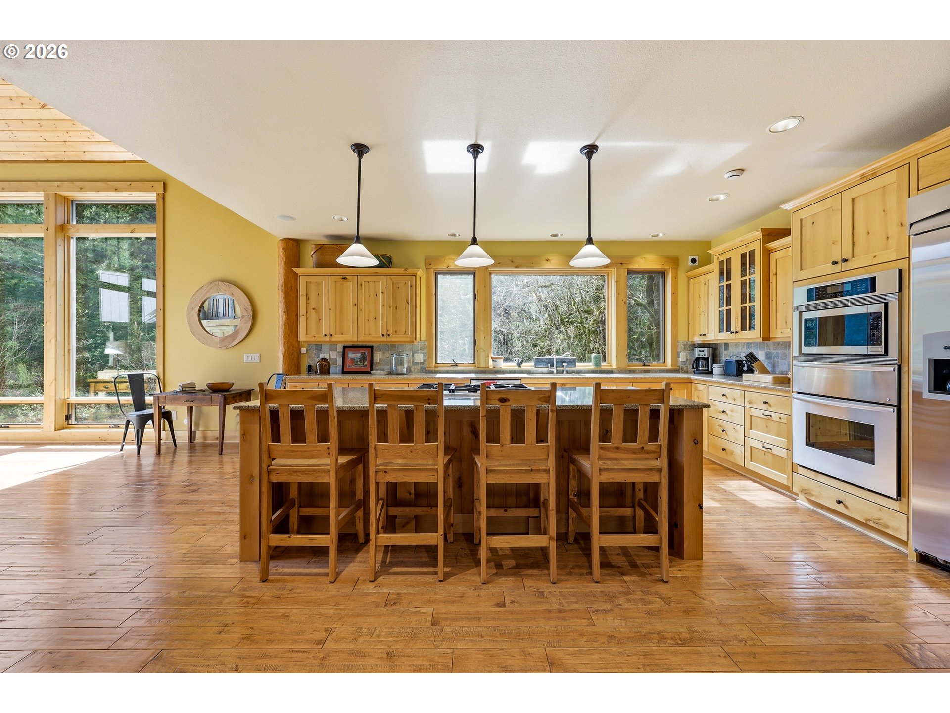 20680 East Glacier View Road Rhododendron, OR 97049 - Photo 8 of 48 a dining hall with stainless steel appliances kitchen island granite countertop a stove a sink a dining table and chairs